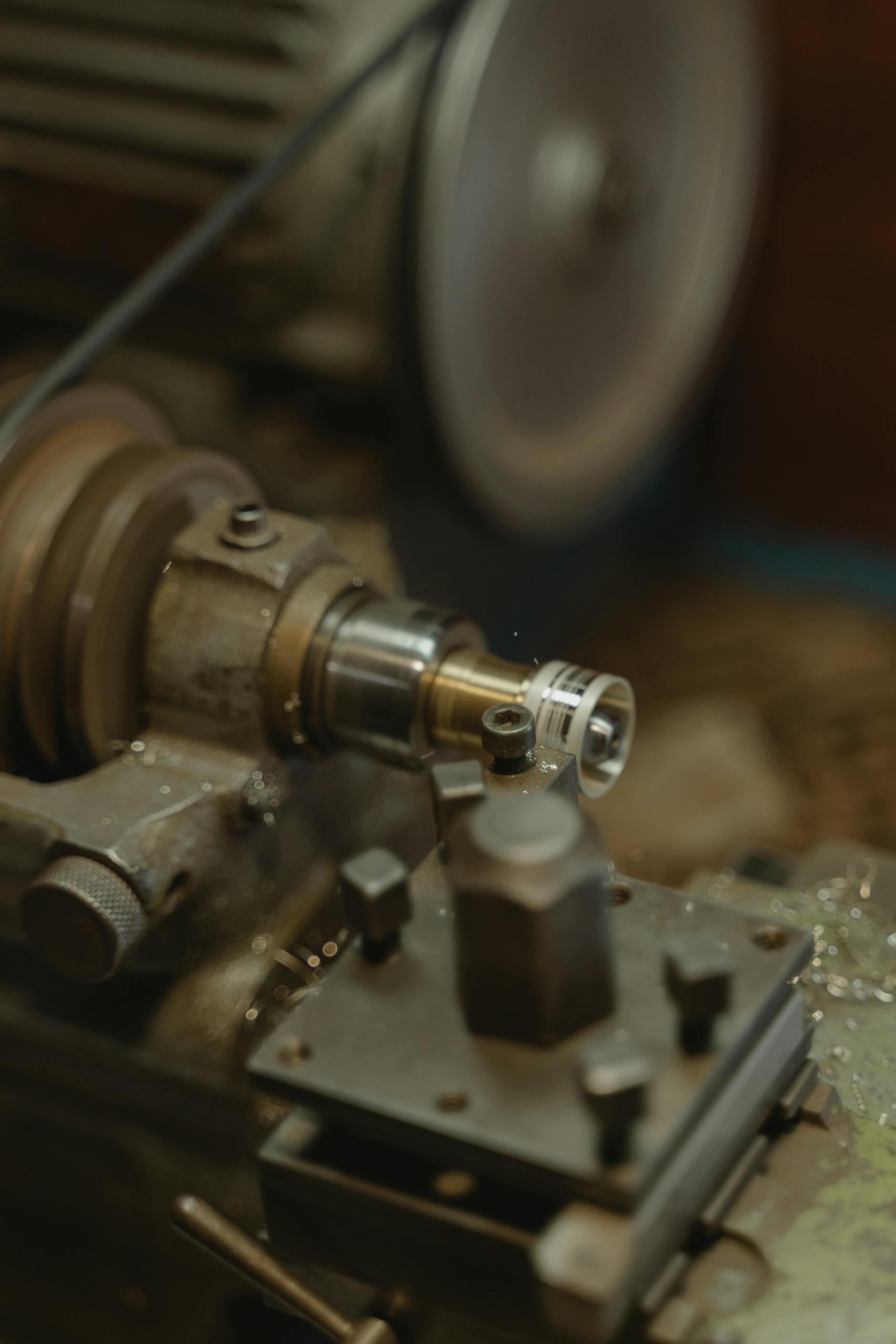 Detailed view of a metal lathe working in an industrial workshop environment.